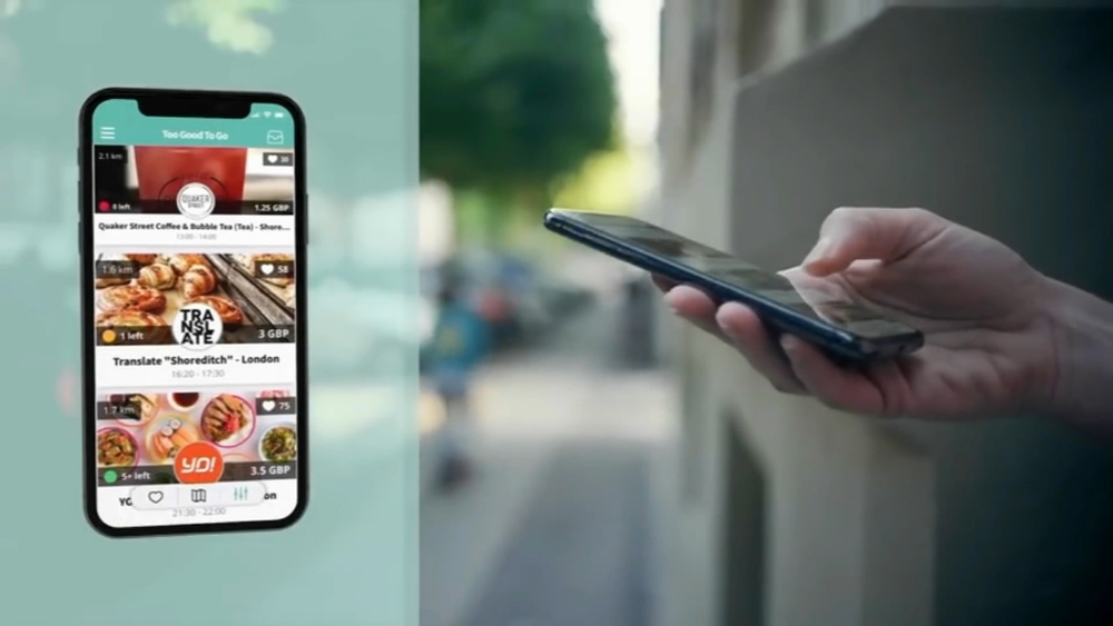 A person holding a smartphone displaying a food delivery app interface